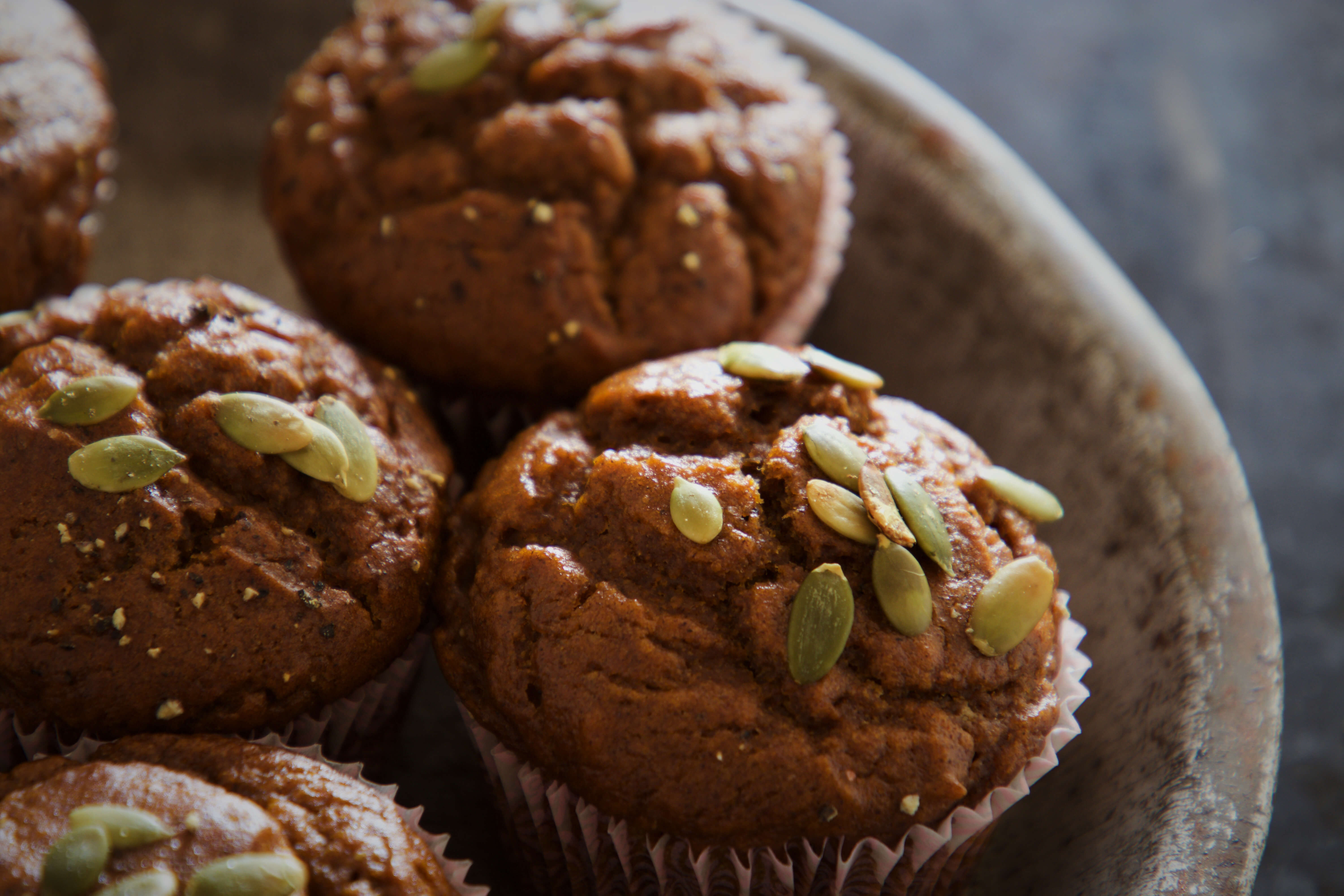 Close up of pumpkin seeded muffins in a dish